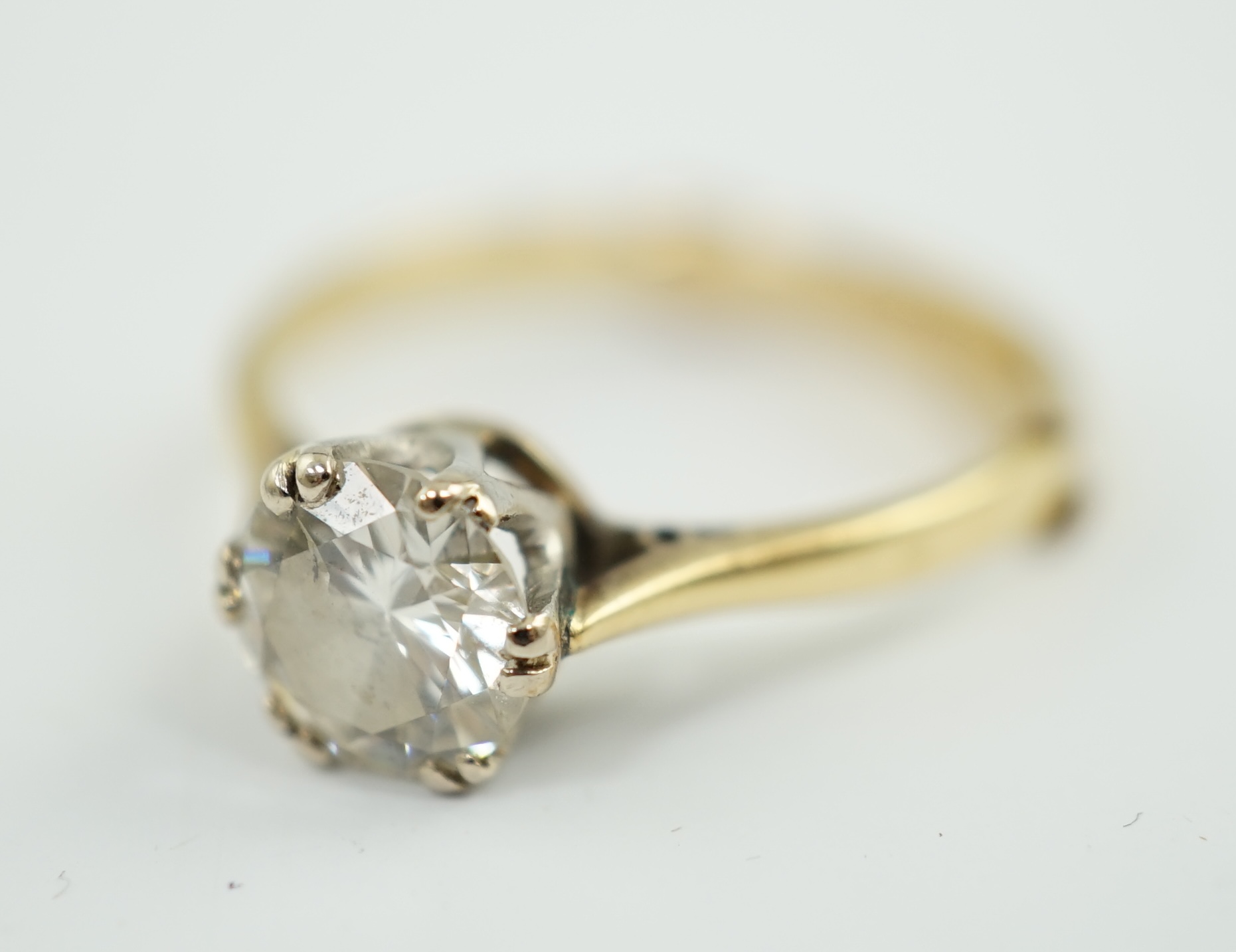 A gold and solitaire diamond set ring